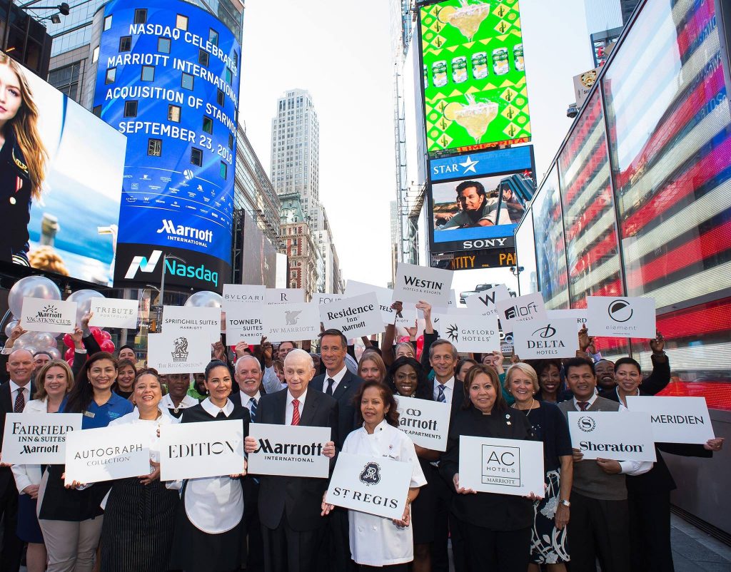 Bill Marriott, executive chairman and chairman of the Board, and Arne Sorenson, president and CEO, Marriott International, join associates in New York City's Times Square to celebrate the merger. 