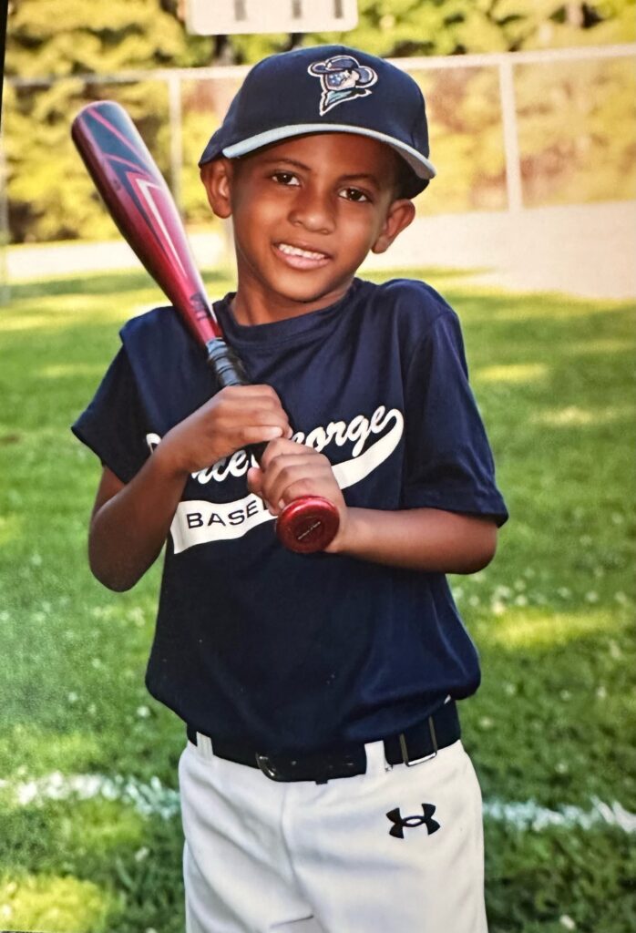 Kevin, CHoR's calendar kid playing baseball