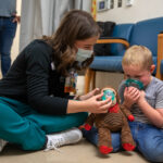 Erin Palm, a Child Life specialist with Penn State Health Children's Hospital, works with 5-year-old Logan during a recent appointment