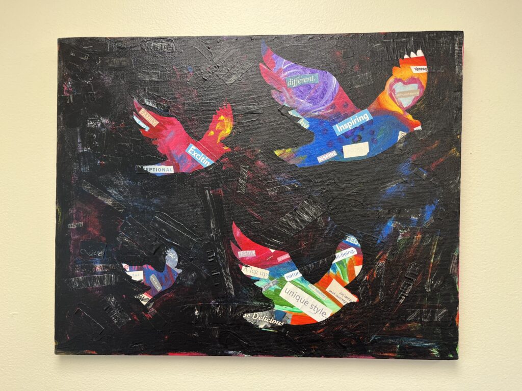 A mixed-media painting of colorful birds and inspiring words hangs in the eating disorder clinic