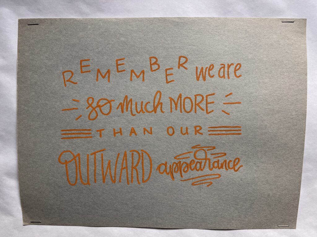 A sign in the clinic reads, "Remember, we are so much more than our outward appearance"