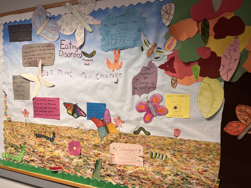 A colorful bulletin board in the clinic is filled with positive words of encouragement and art projects