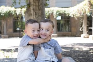 Twin brothers Brantley and Braxton Headrick hug one another in the courtyard outside the UC Davis MIND Institute.