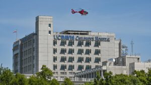 UC Davis Children's Hospital with a helicopter hovering overhead.