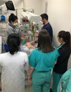 Doctors training on an infant manikin