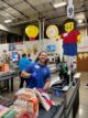 Sales associate at register gives thumbs up in Costco