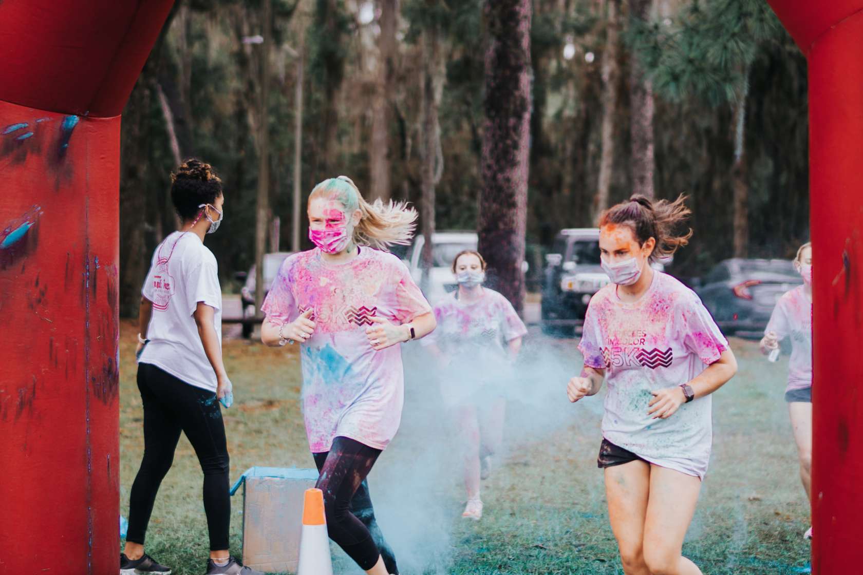 Participants run through powdered color at the Miracles in Color 5K.